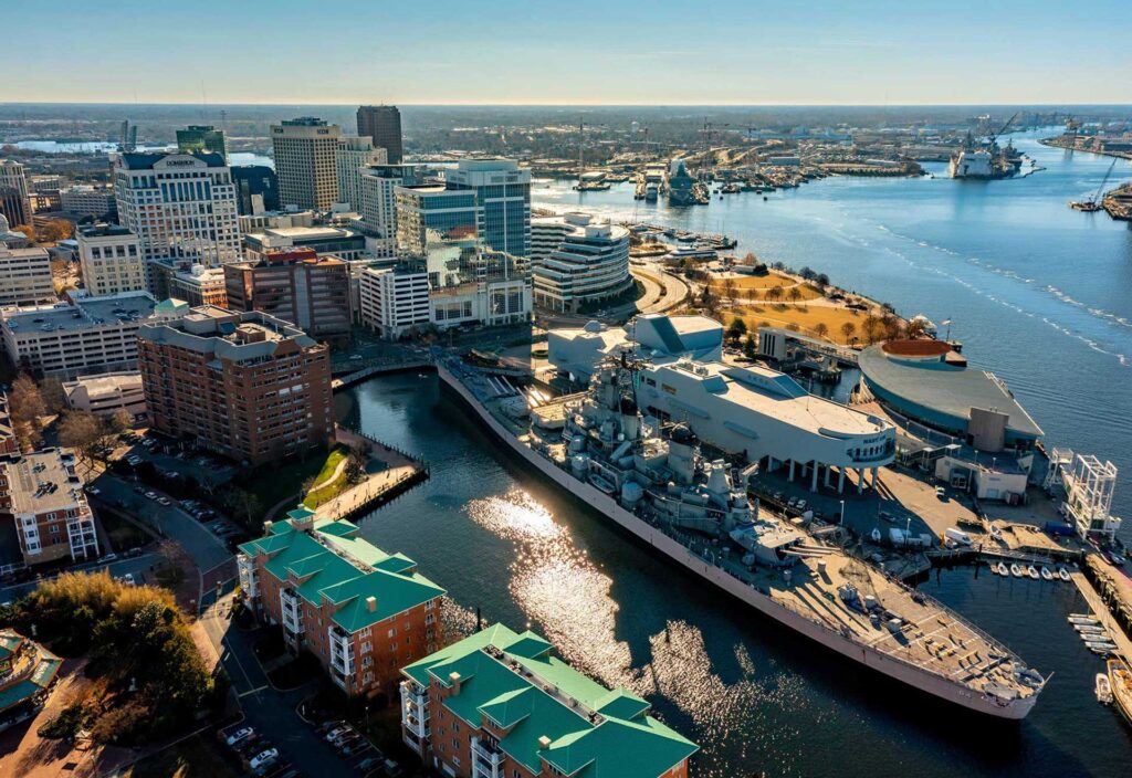 Aerial of downtown Norfolk and the Battleship Wisconsin on the Elizabeth River